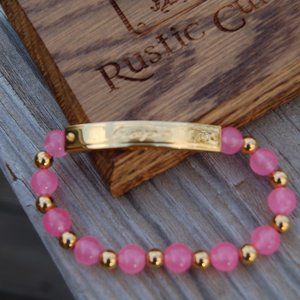 Rustic Cuff Pink glass beaded bracelet with gold bar with the script word "Hope"
